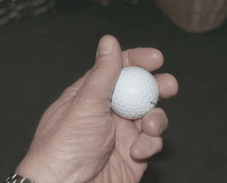 A golfer who is showing one of the cheapest golf balls