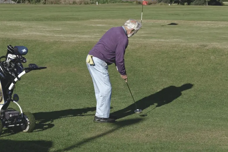 Senior Golfer playing with  a golf club for seniors  
