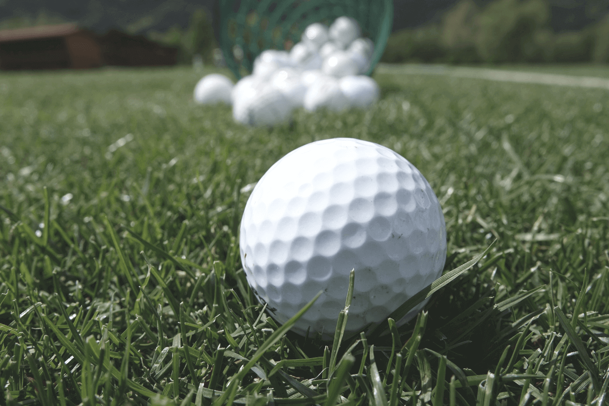 Golf balls in the ground on the putting green
