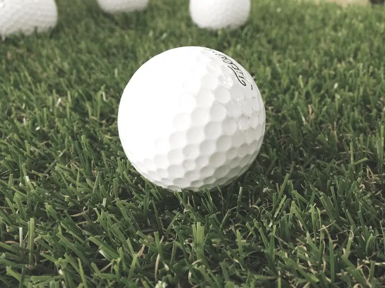 Golf balls in the ground on the putting green
