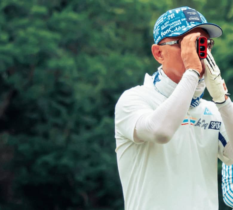 A Golfer Who's measuring the distance with a golf rangefinder
